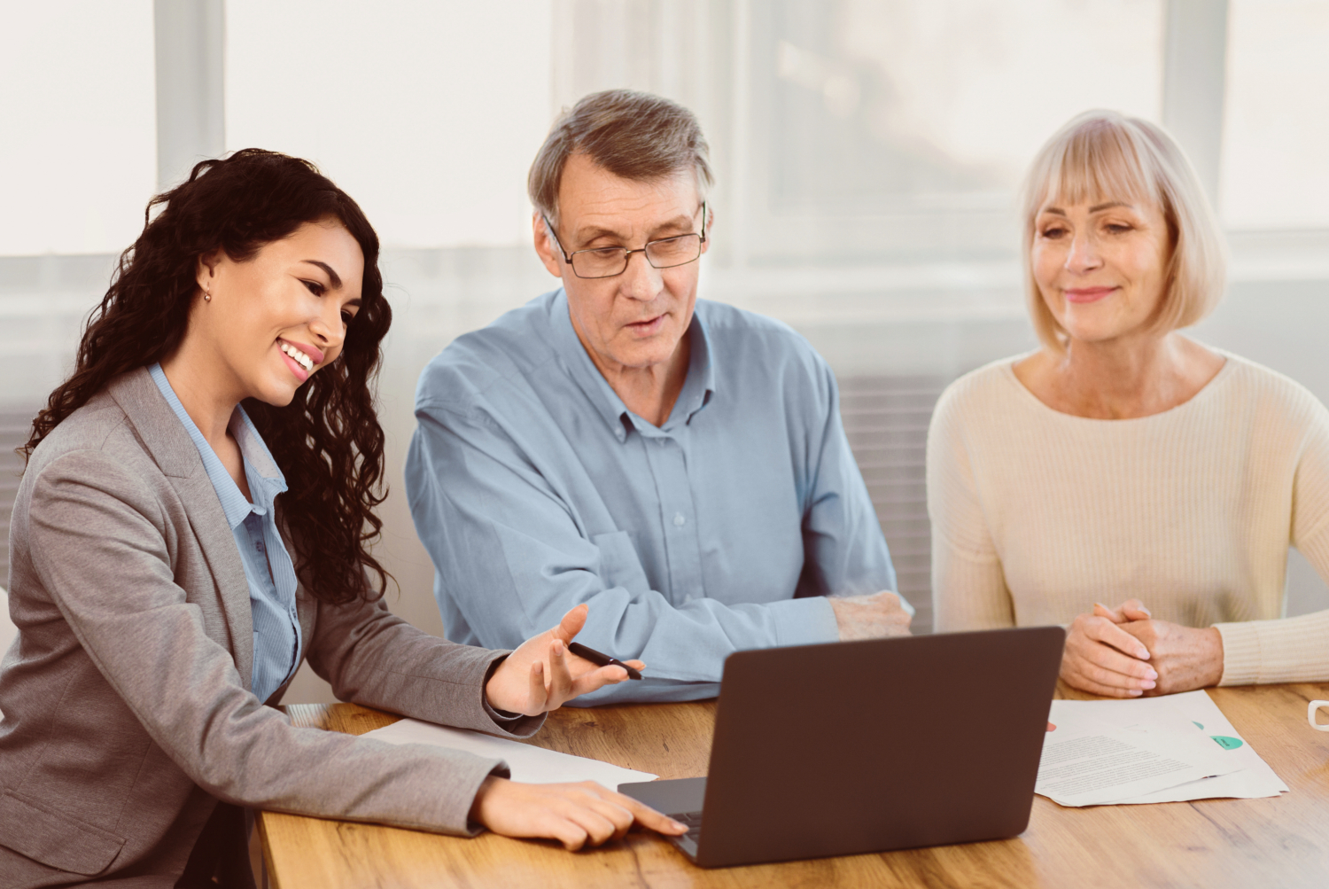 Elderly couple consulting with financial advisor at home