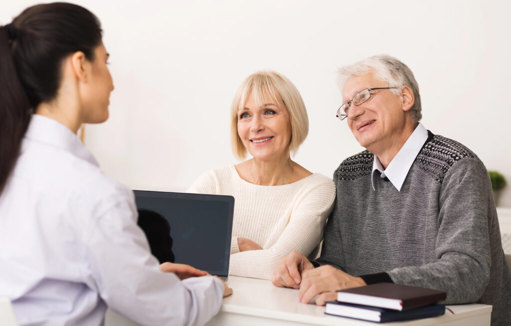 older couple sits with medicare broker