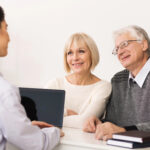older couple sits with medicare broker